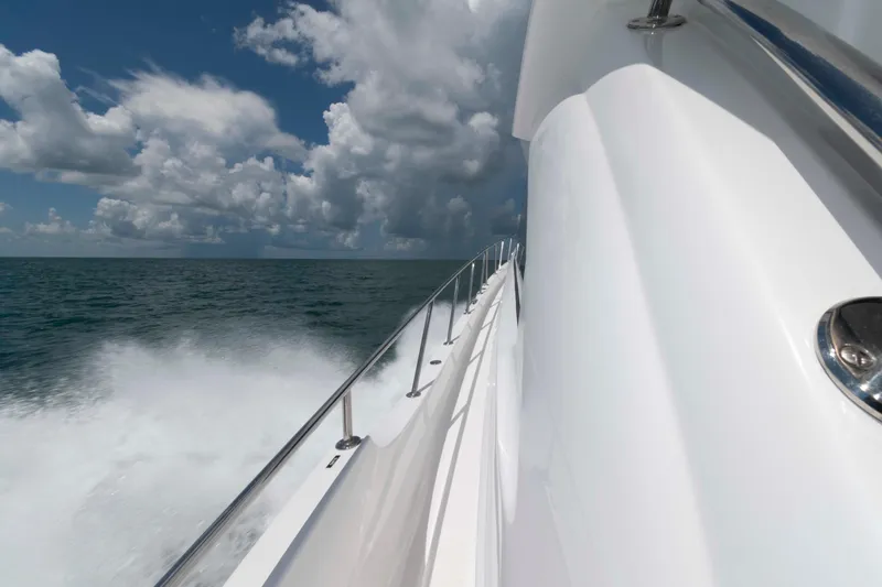 Slide: The Image of 2009 Hatteras 60 Motor Yacht cruising on open sea under cloudy sky. - 34