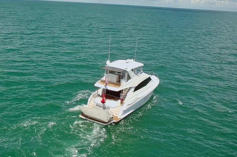 Slide: The Image of 2009 Hatteras 60 Motor Yacht cruising on open sea, aerial view. - 4