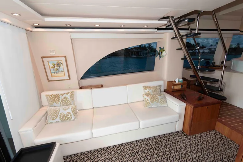 Slide: The Image of Luxurious interior of 2009 Hatteras 60 Motor Yacht with white sofa and spiral staircase. - 40