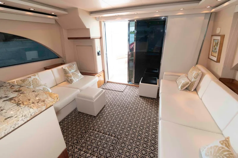 Slide: The Image of Luxurious interior of 2009 Hatteras 60 Motor Yacht with elegant seating and decor. - 45