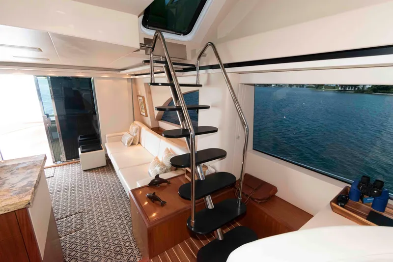 Slide: The Image of Luxurious interior of 2009 Hatteras 60 Motor Yacht with modern staircase and scenic window view. - 55
