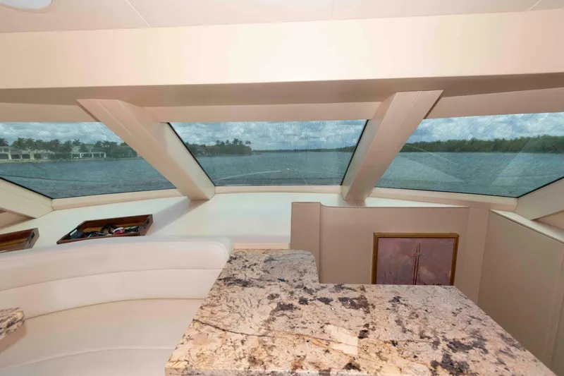Slide: The Image of Interior view of 2009 Hatteras 60 Motor Yacht with panoramic windows and elegant decor. - 56