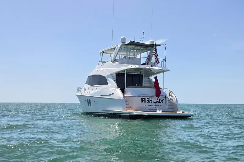 Slide: The Image of 2009 Hatteras 60 Motor Yacht "Irish Lady" on open water, clear sky background. - 6