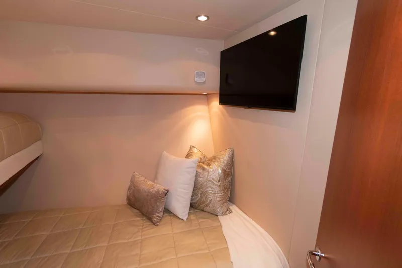 Slide: The Image of Cozy bedroom in 2009 Hatteras 60 Motor Yacht with TV and plush pillows. - 73