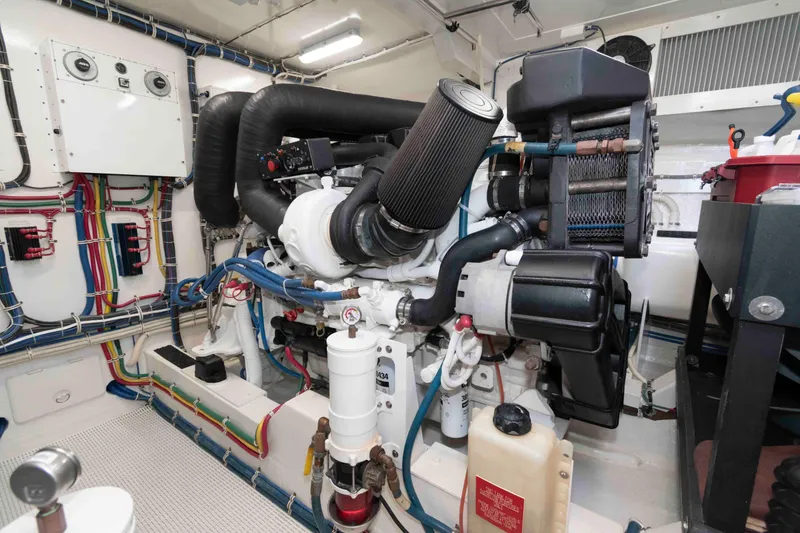 Slide: The Image of Engine room of 2009 Hatteras 60 Motor Yacht with complex machinery and wiring. - 77