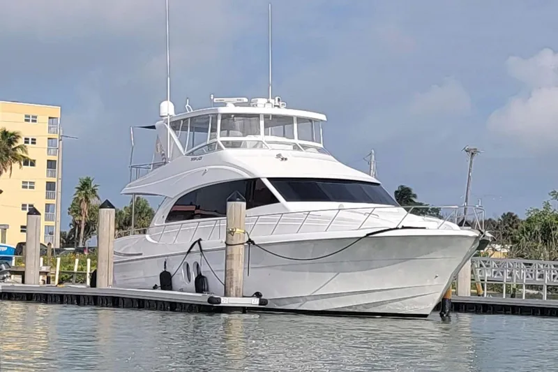 Slide: The Image of 2009 Hatteras 60 Motor Yacht docked at marina, clear sky background. - 8