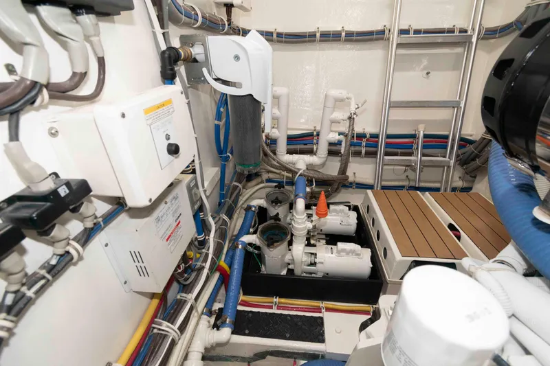 Slide: The Image of Engine room of 2009 Hatteras 60 Motor Yacht with complex wiring and machinery. - 83