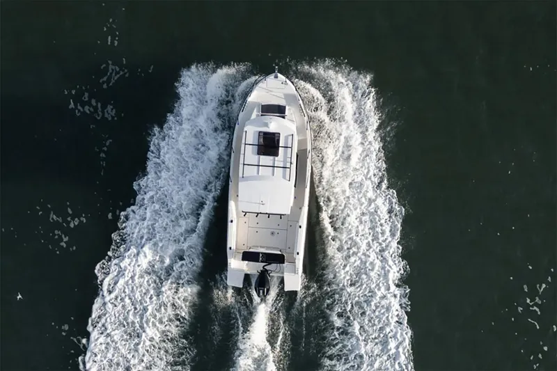 Slide: The Image of Manufacturer Provided Image: 2025 Bayliner Trophy T25 Pilothouse cruising on water, aerial view. - 2