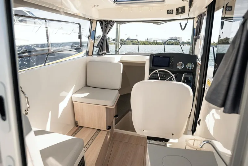 Slide: The Image of Manufacturer Provided Image: Interior of 2025 Bayliner Trophy T25 Pilothouse, featuring modern seating and navigation controls. - 4