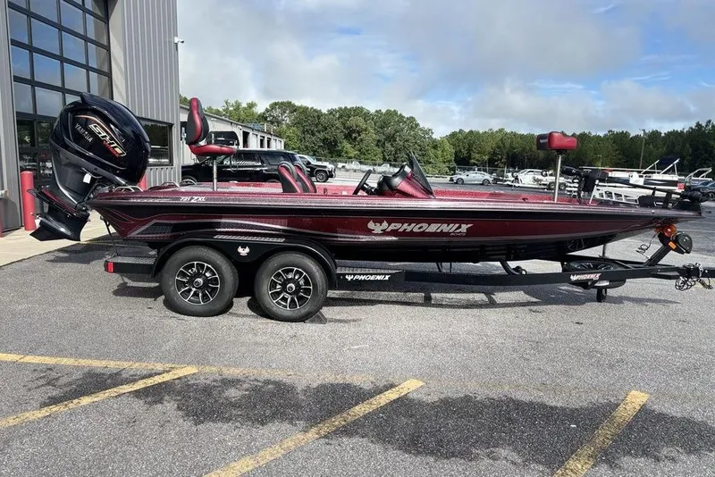 Slide: The Image of 2026 Phoenix 721 ZXL boat on trailer, parked outdoors near a building. - 1