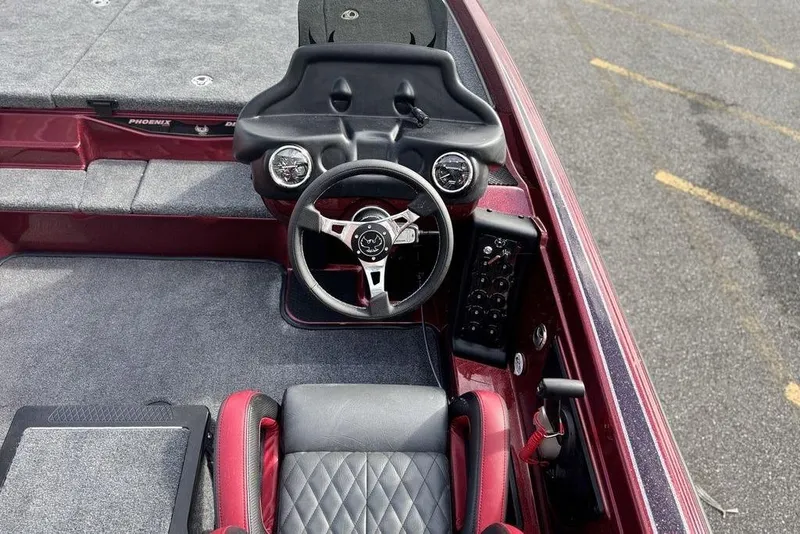 Slide: The Image of 2026 Phoenix 721 ZXL boat cockpit with steering wheel and control panel. - 12
