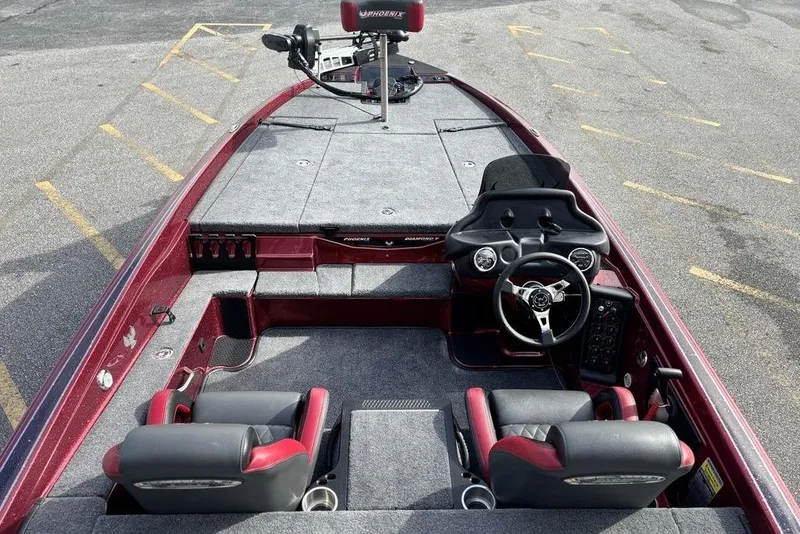 Slide: The Image of 2026 Phoenix 721 ZXL boat interior with dual seats and steering wheel, parked on asphalt. - 13