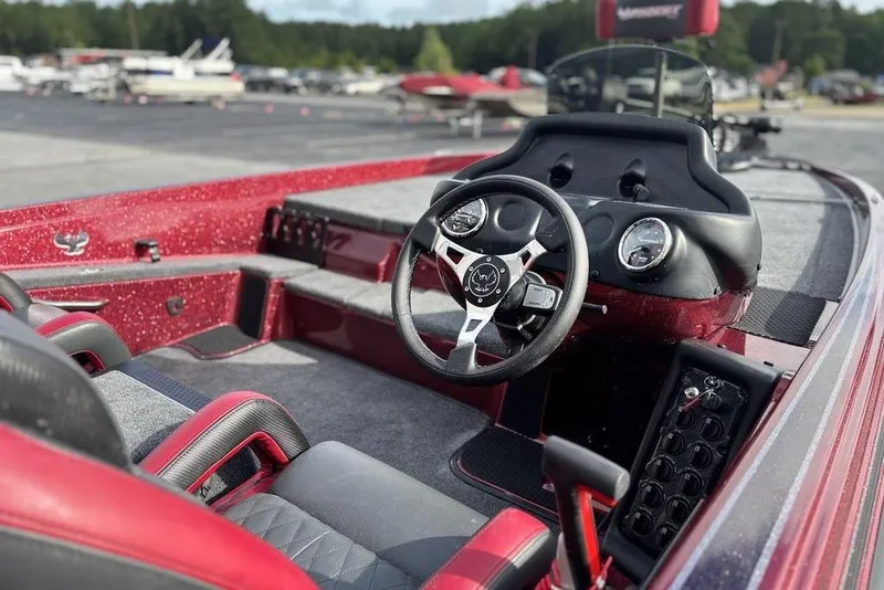 Slide: The Image of 2026 Phoenix 721 ZXL boat interior with red and black seating, steering wheel, and dashboard. - 14