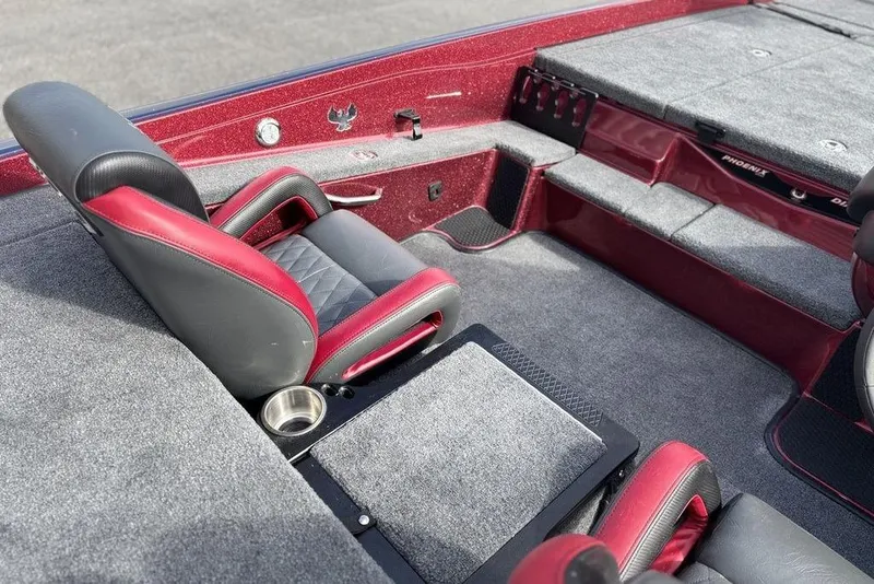 Slide: The Image of Interior of 2026 Phoenix 721 ZXL boat with red and black seating, carpeted flooring. - 16