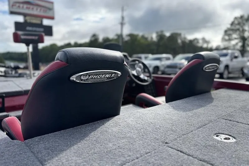 Slide: The Image of 2026 Phoenix 721 ZXL boat seats with logo, parked outdoors. - 17