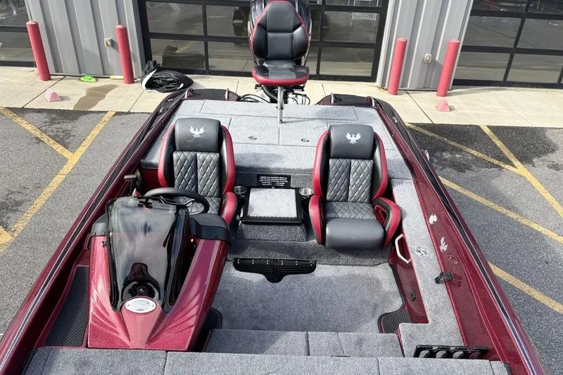 Slide: The Image of 2026 Phoenix 721 ZXL boat interior with red and black seating, parked outside. - 18