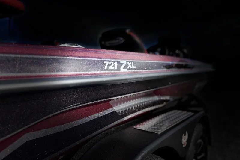 Slide: The Image of 2026 Phoenix 721 ZXL boat, close-up view with sleek design and branding. - 2