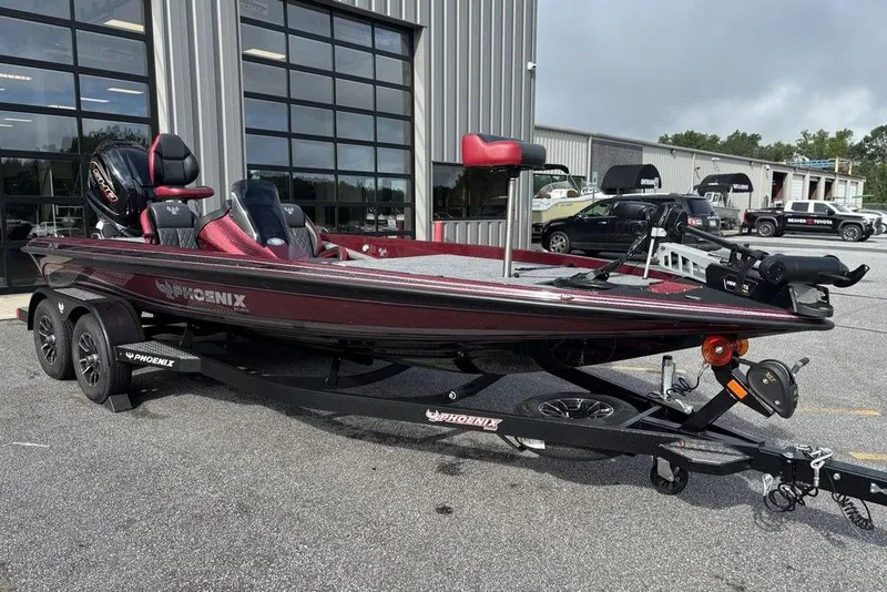 Slide: The Image of 2026 Phoenix 721 ZXL bass boat on trailer, parked outside dealership. - 3