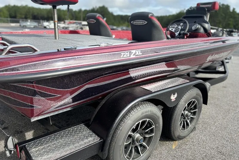 Slide: The Image of 2026 Phoenix 721 ZXL boat on trailer, featuring sleek design and dual axles. - 4