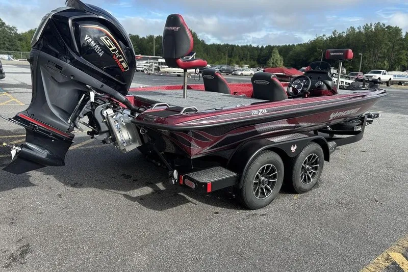 Slide: The Image of 2026 Phoenix 721 ZXL bass boat with Yamaha engine on a trailer in a parking lot. - 9