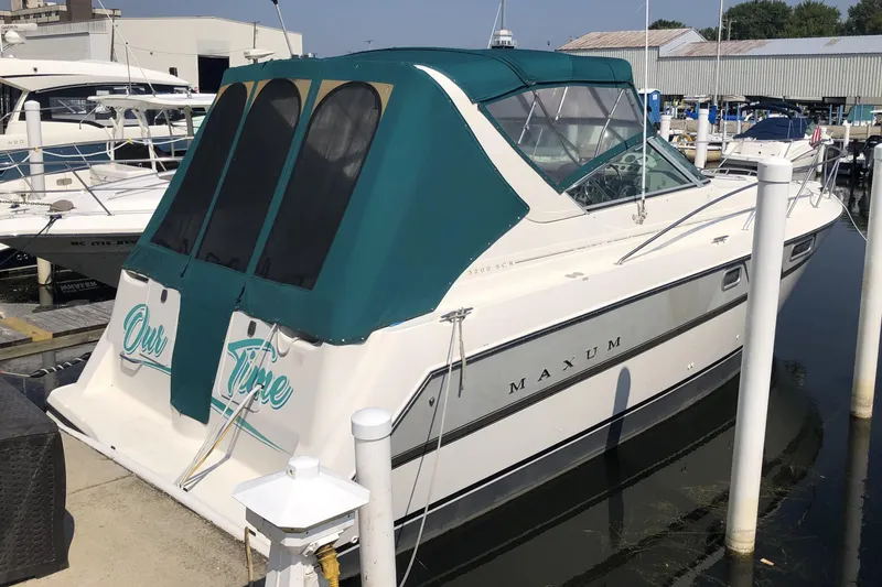 The Image of 1995 Maxum 3200 SCR boat docked, featuring teal canopy and "Our Time" text on stern. - 0