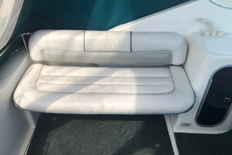 Slide: The Image of White leather seating on a 1995 Maxum 3200 SCR boat interior. - 11