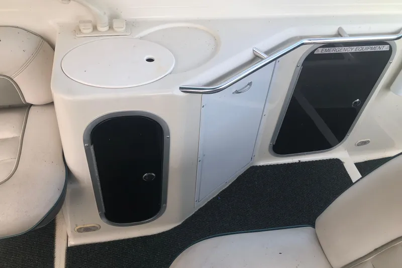 Slide: The Image of 1995 Maxum 3200 SCR boat interior with storage compartments and emergency equipment signage. - 13