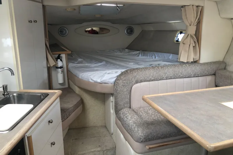 Slide: The Image of Interior of 1995 Maxum 3200 SCR boat with bed, seating, and kitchenette. - 14