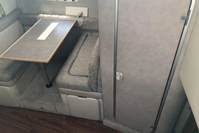 Slide: The Image of 1995 Maxum 3200 SCR cabin interior with dining area and seating. - 16