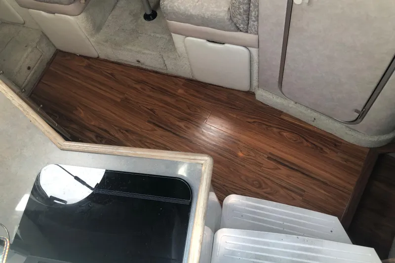 Slide: The Image of Interior of 1995 Maxum 3200 SCR boat with wood flooring and seating area. - 17