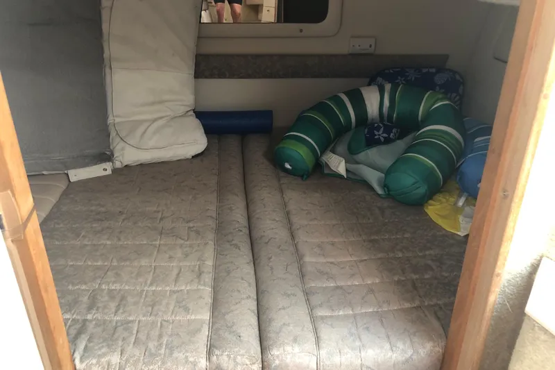 Slide: The Image of Interior cabin of 1995 Maxum 3200 SCR boat with cushions and bedding. - 21