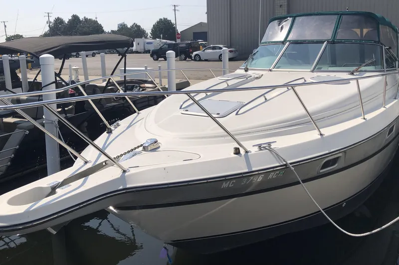 Slide: The Image of 1995 Maxum 3200 SCR boat docked at marina, featuring sleek design and white exterior. - 6