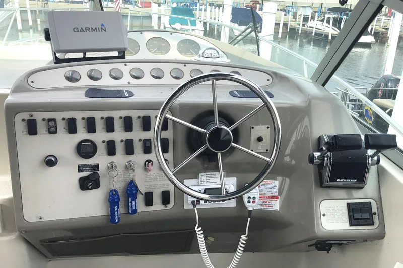 Slide: The Image of 1995 Maxum 3200 SCR boat dashboard with steering wheel and Garmin navigation system. - 8
