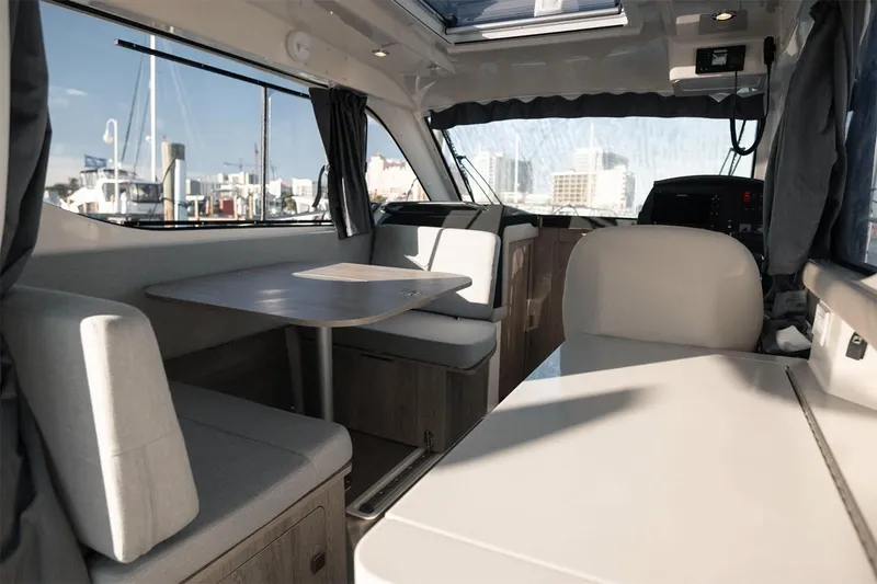 Slide: The Image of Manufacturer Provided Image: Interior of 2025 Bayliner Trophy T29 Explorer, featuring seating and dining area. - 6