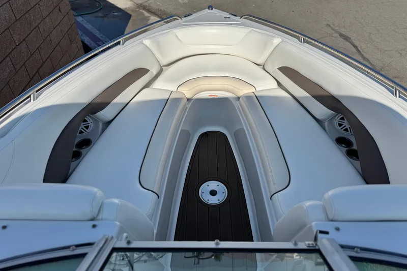Slide: The Image of 2007 Crownline 270 BR boat interior with white seating and cup holders. - 10