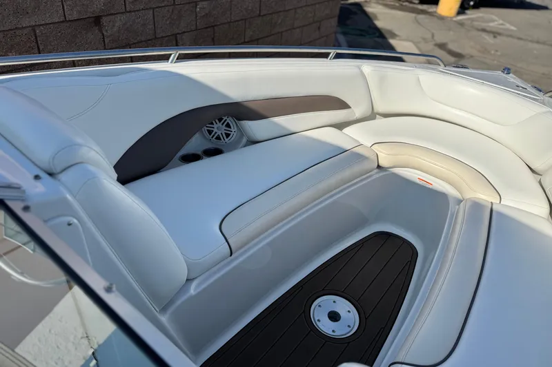 Slide: The Image of 2007 Crownline 270 BR boat interior with white seating and speaker detail. - 11