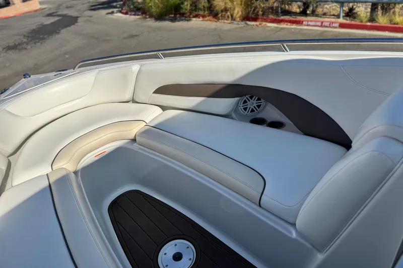 Slide: The Image of 2007 Crownline 270 BR boat interior with white seating and cup holders. - 12