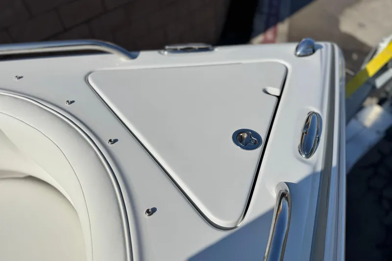Slide: The Image of 2007 Crownline 270 BR boat deck with stainless steel fittings and storage compartment. - 13