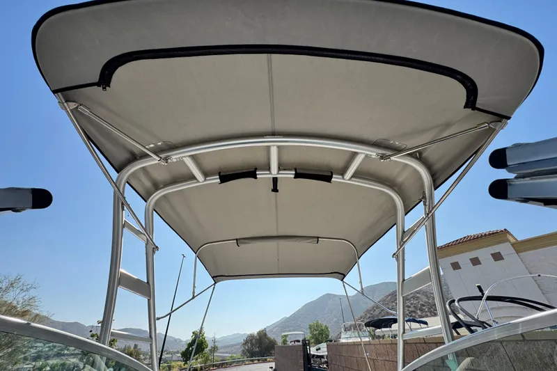 Slide: The Image of 2007 Crownline 270 BR boat canopy with metal frame, set against a clear blue sky. - 15