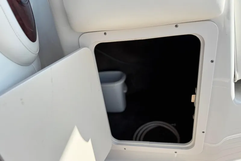 Slide: The Image of Open storage compartment on 2007 Crownline 270 BR boat, showing interior space. - 20
