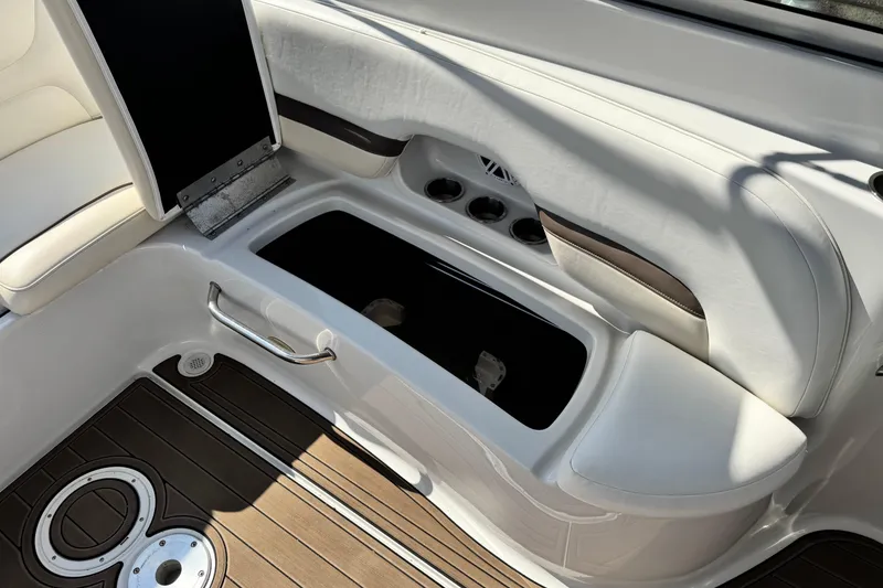 Slide: The Image of 2007 Crownline 270 BR boat interior with white seating and storage compartment. - 21