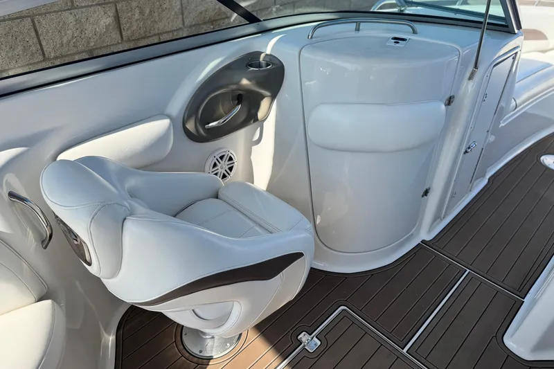 Slide: The Image of 2007 Crownline 270 BR boat interior with white seating and wood-style flooring. - 25