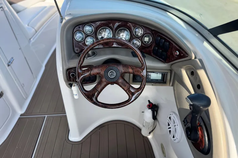 Slide: The Image of 2007 Crownline 270 BR boat dashboard with wood accents and steering wheel. - 29