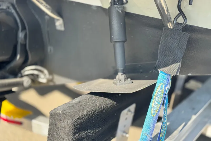 Slide: The Image of Close-up of 2007 Crownline 270 BR boat trailer with blue strap and black padding. - 6