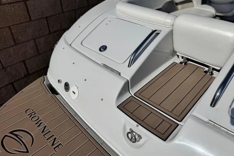 Slide: The Image of 2007 Crownline 270 BR boat stern with teak-style decking and white seating. - 7