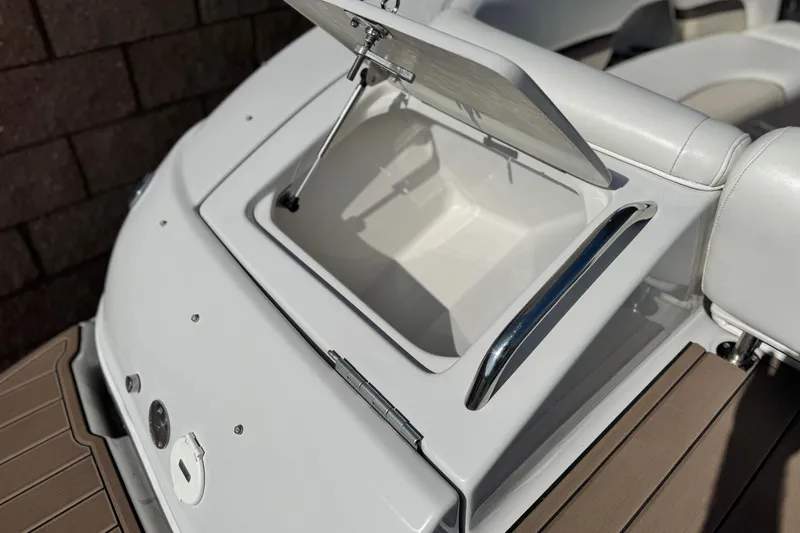 Slide: The Image of Open storage compartment on 2007 Crownline 270 BR boat, featuring sleek white and chrome design. - 8