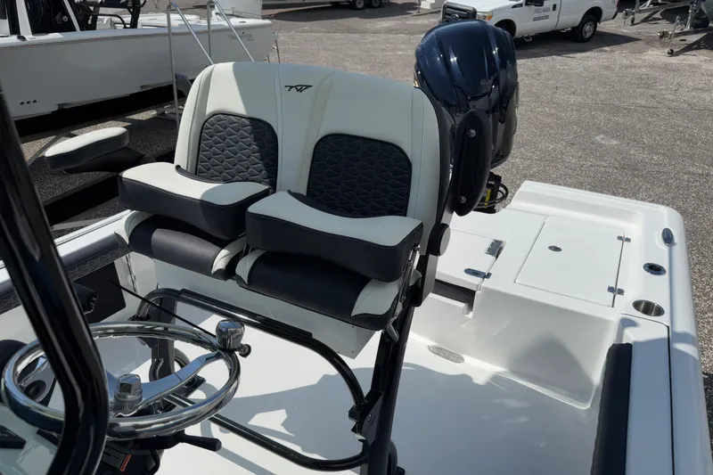 Slide: The Image of 2026 Tidewater 2300 Carolina Bay boat interior with dual seats and steering wheel. - 14