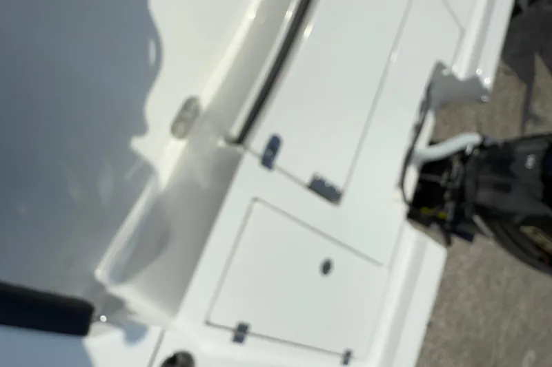 Slide: The Image of Blurry view of a 2026 Tidewater 2300 Carolina Bay boat's deck and engine. - 15