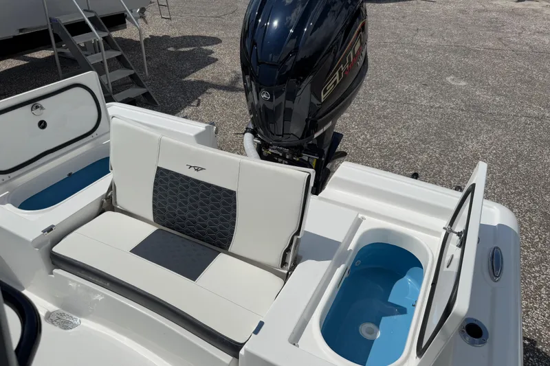 Slide: The Image of 2026 Tidewater 2300 Carolina Bay boat interior with seating and open storage compartments. - 17