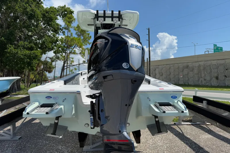 Slide: The Image of 2026 Tidewater 2300 Carolina Bay boat with Yamaha engine, displayed outdoors. - 5